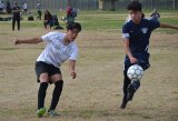 Lemoore's Diego Ceja keeps his eye on the ball in Saturday's match against Redwood High in the Jim Inglis Soccer Tournament.